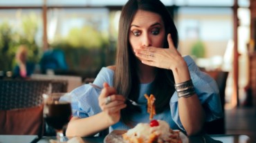 woman feeling guilty eating vegan food